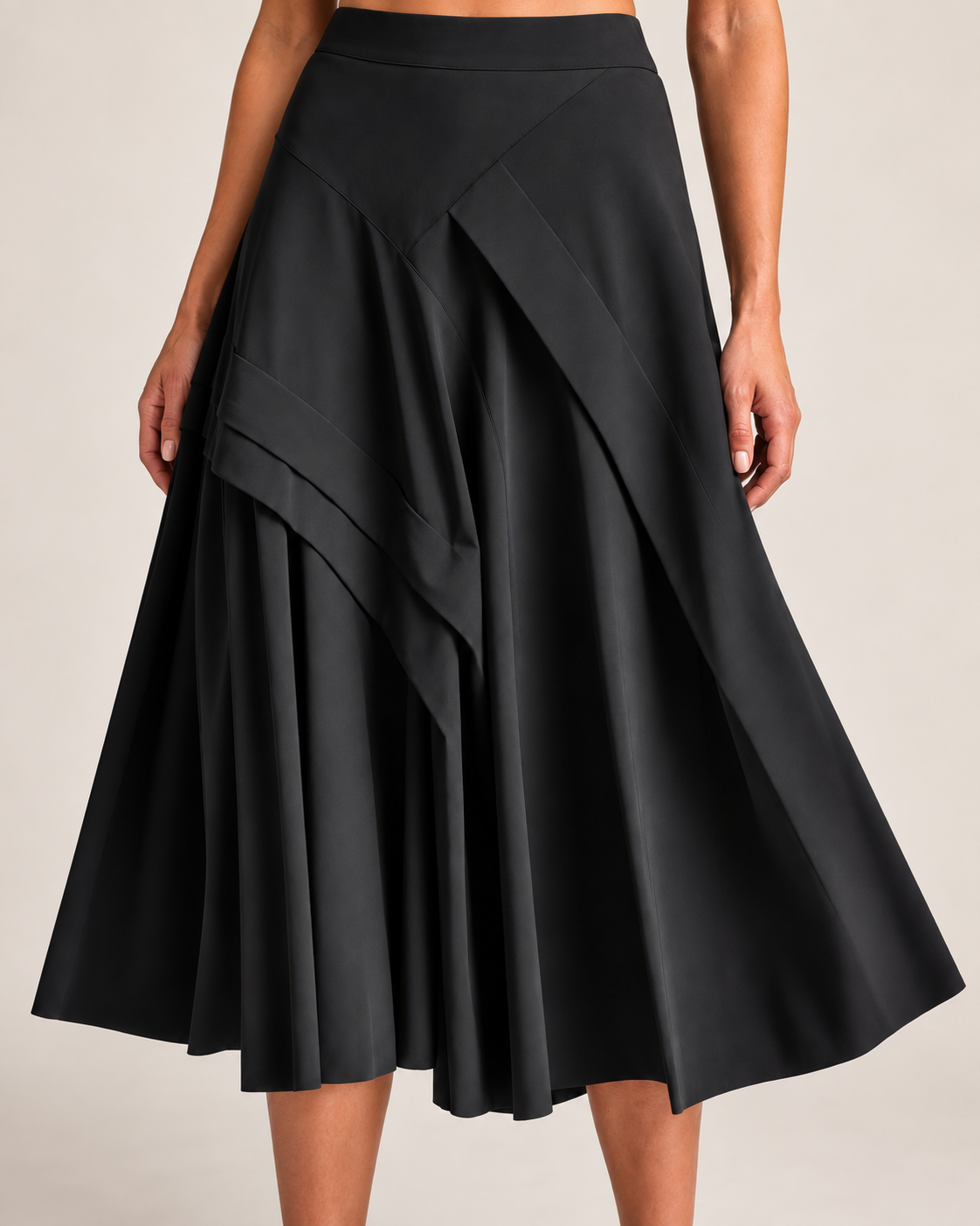 Close detail of the black Waterfall Skirt showing its smooth waistband and asymmetric layered panels
