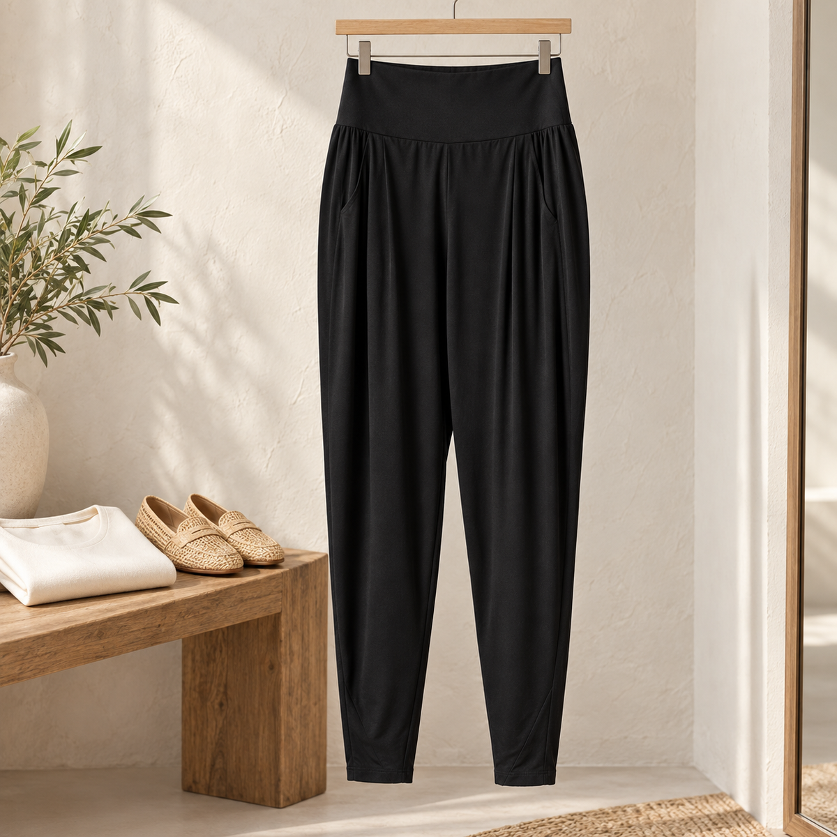 Black Basque Pant hanging naturally in a light dressing room